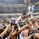 Lionel Messi of Argentina celebrates with teammates and the FIFA World Cup Qatar 2022 Winner's Trophy after the team's victory  during the FIFA World Cup Qatar 2022 Final match between Argentina and France at Lusail Stadium on December 18, 2022 in Lusail City, Qatar. (Photo by Clive Brunskill/Getty Images)