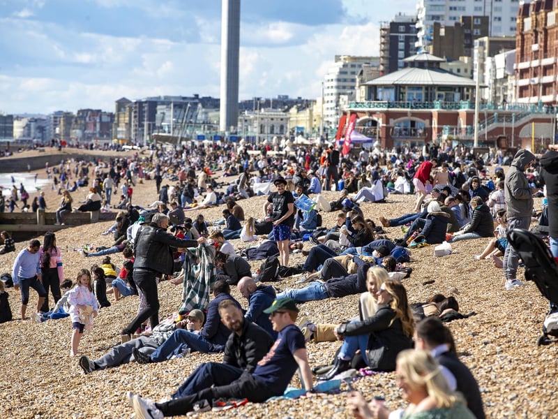 People enjoy the spring sunshine this Good Friday on Brighton beach in East Sussex.