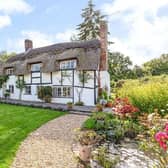 This stunning thatched cottage with beautiful gardens and a separate annexe has gone on the market through agents Savills with a guide price of £1,295,000.