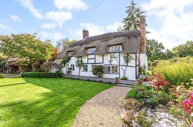 This stunning thatched cottage with beautiful gardens and a separate annexe has gone on the market through agents Savills with a guide price of £1,295,000.