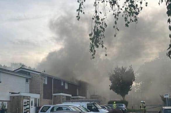 Smoke billows from the house in Webb Close, Broadfield. Photo: Edwin Smith