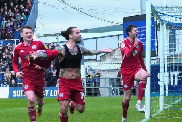 Dom Telford celebrates his goal with James Tilley and Ashley Nadesan