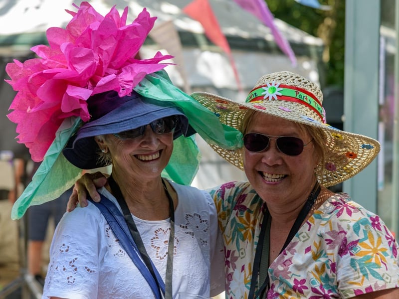 Maggie Sherburn, winner of the creative hat competition, with volunteer Nancy Elliott