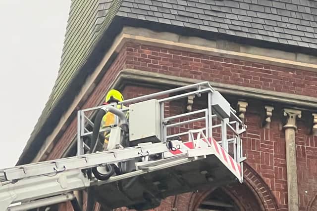 Fire crews were called to assist the RSPCA after a pigeon became stuck on a church spire in Worthing. Photo: Eddie Mitchell