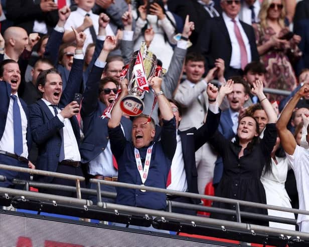 LONDON, ENGLAND - MAY 19: Scott Lindsey, Manager of Crawley Town, lifts the Sky Bet League Two Play-Off Final trophy after the team's victory in the Sky Bet League Two Play-Off Final match between Crawley Town and Crewe Alexandra at Wembley Stadium on May 19, 2024 in London, England. (Photo by Paul Harding/Getty Images)