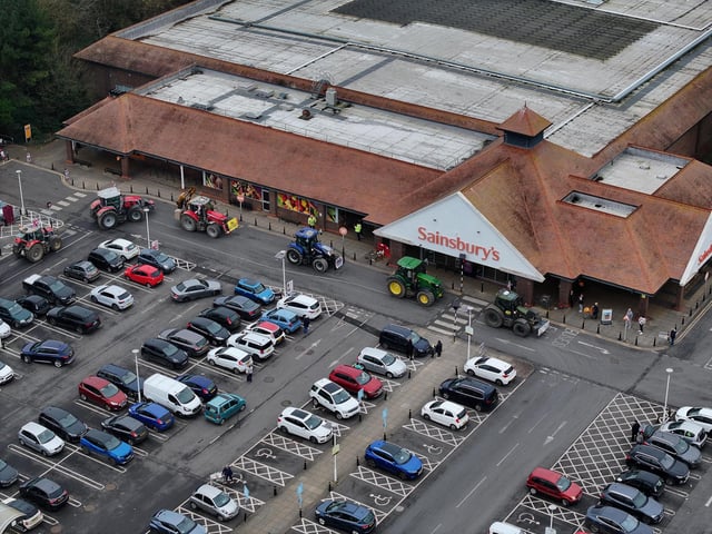The convoy moves past Sainsburys.