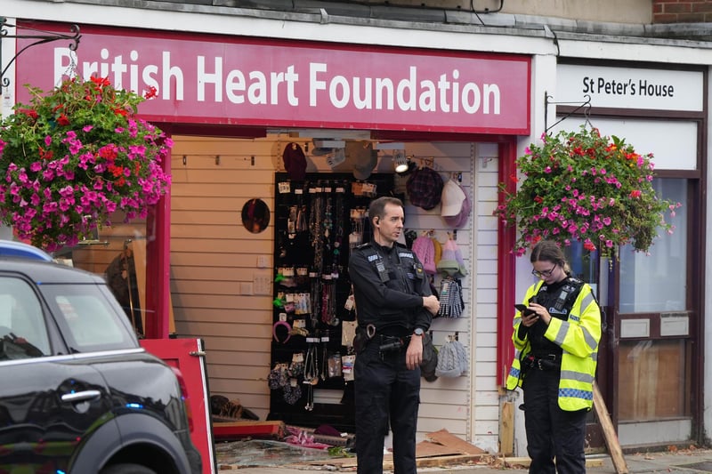 One person has been rescued after a car collided with a charity shop in Chichester.