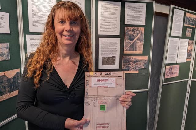 Mary Candy, Southwick Society chairman, with top secret documents relating to the Cold War air crash