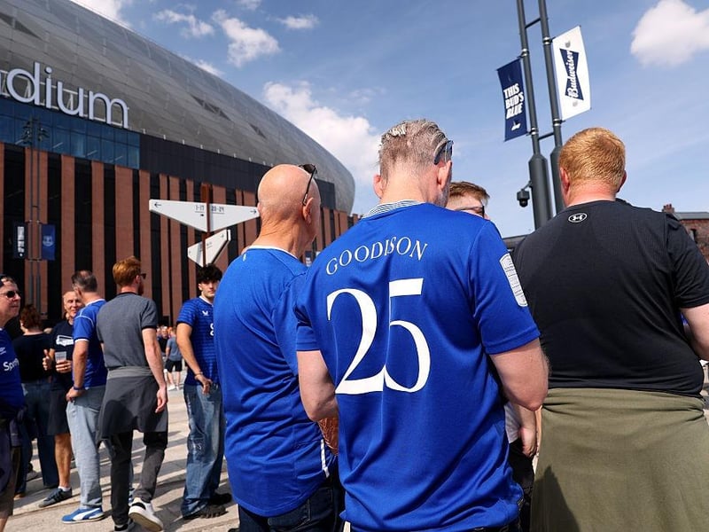 A fan of Everton is seen wearing a replica shirt which reads "Goodison, 25" as they enjoy the pre-match atmosphere outside the stadium, prior to the Premier League match between Everton and Brighton & Hove Albion at Hill Dickinson Stadium