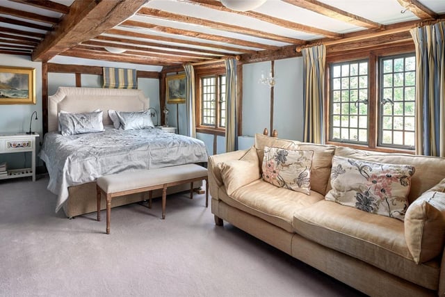 A large and elegant bedroom situated on the west of the property, featuring the mill's charasmatic beams.