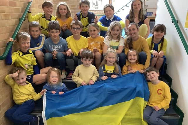 Holy Trinity C of E Primary School pupils dressed in blue and yellow