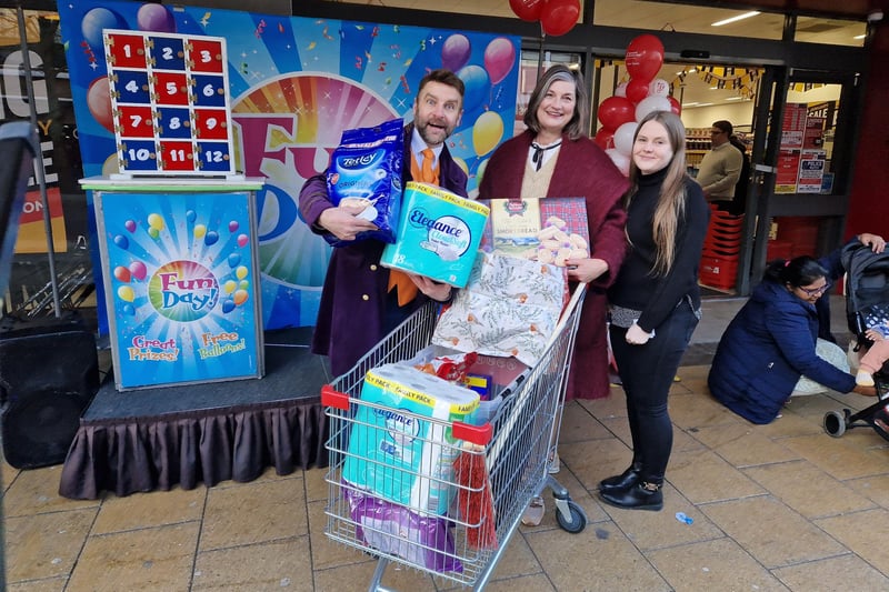 Poundstretcher's resident entertainer Ian Gee with Su Parrish from The Easter team and her trolley dahs haul, and area manager April Hildred