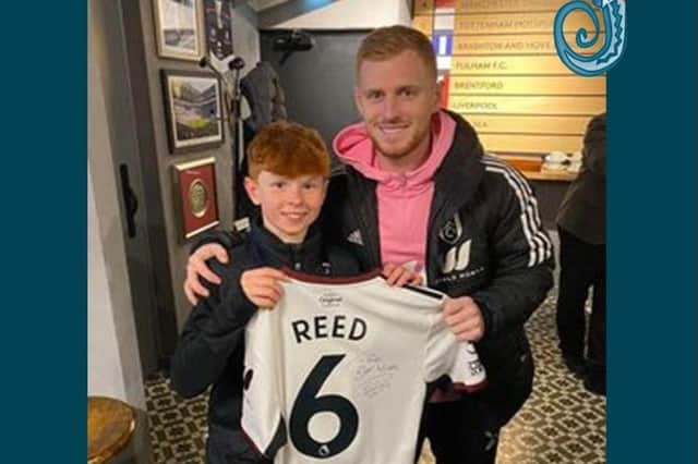 Professional footballer and ex Durrington High student Harrison Reed presents a signed Fulham shirt to Rossi