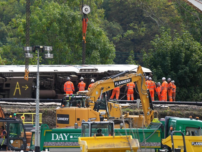 The train seen on its side before the cranes start lifting