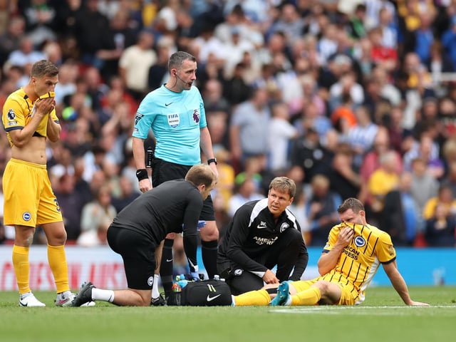 James Milner of Brighton & Hove Albion receives medical treatment before being substituted off at Arsenal