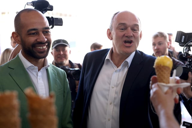 EASTBOURNE, ENGLAND - MAY 24: Liberal Democrat leader Ed Davey with Liberal Democrat candidate Josh Babarinde get an ice cream during a visit to the marginal seat of Eastbourne on May 24, 2024 in Eastbourne, England. The Liberal Democrats are targeting Conservative marginal seats along the South Coast in the upcoming general election on July 4th.  (Photo by Dan Kitwood/Getty Images)