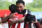 Louie Watson gets a hug from Crawley Town head coach Colin Kazim-Richards after the Salford draw | Picture: Natalie Mayhew/Butterfly Football
