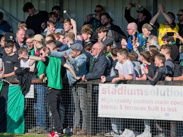 Burgess Hill Town players, fans and staff celebrate surviving in the Isthmian south east division at the end of their 0-0 draw with Beckenham