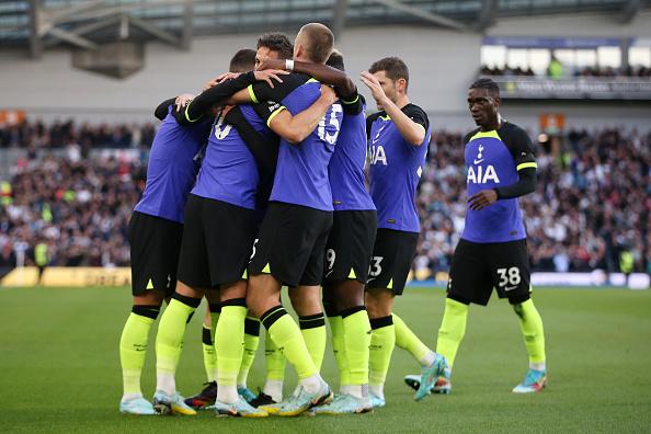Harry Kane of Tottenham Hotspur celebrates with teammates after scoring their team's first goal during the Premier League match between Brighton & Hove Albion