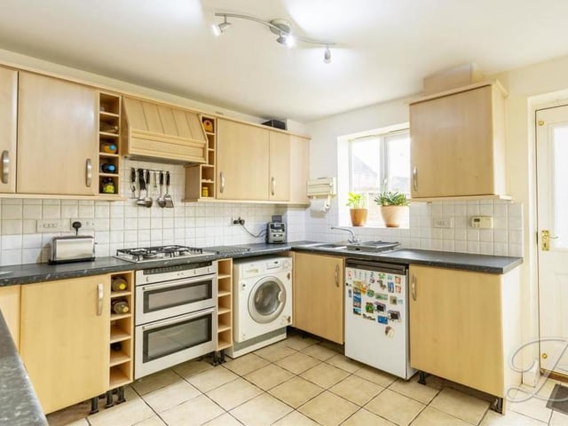 The kitchen really does have all you need, including an inset sink and drainer with a mixer tap above. The window faces the back of the property, while the door provides access to the back garden.
