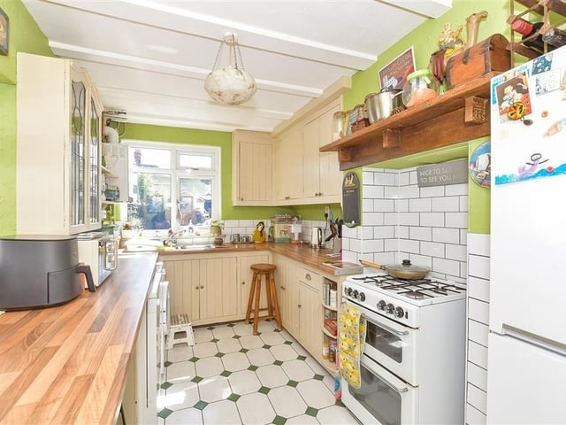 The kitchen measures 14ft4in x 7ft11in