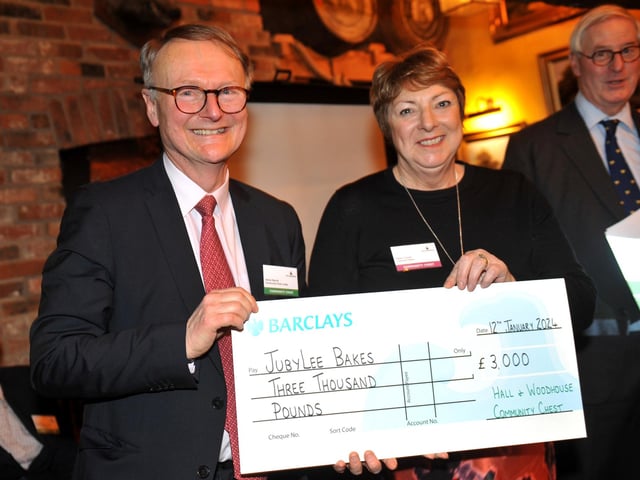 Judge Adrian Barrott presents a cheque for £3,000 to JubyLee Bakes