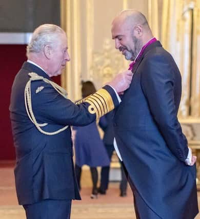 Marc receiving his OBE from HRH King Charles, then the Prince of Wales in 2021.