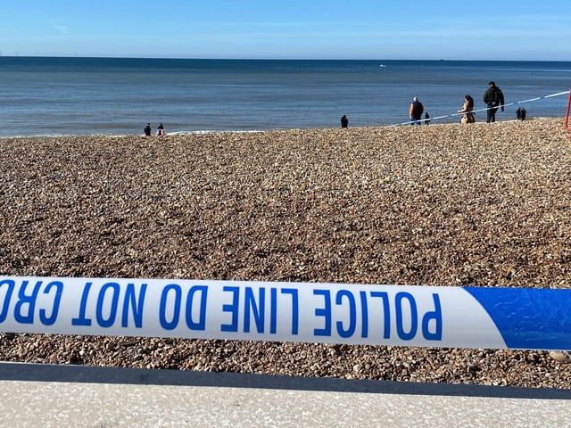 Police officers have taped off a section of Brighton beach after the discovery of a 'suspected mine'