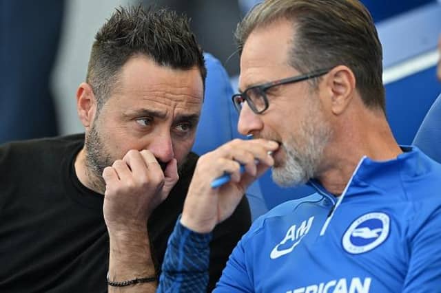 Brighton's Italian head coach Roberto De Zerbi (L) chats with his assistant Andrea Maldera