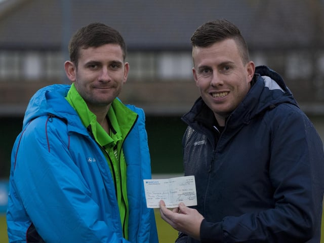 Receiving a cheque from Ian Guppy to help pay for a shoulder operation