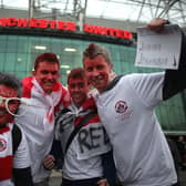 Fans of Crawley Town enjoy the atmosphere outside Old Trafford as their team prepare to take on Manchester United in the FA Cup fifth round on February 19, 2011.