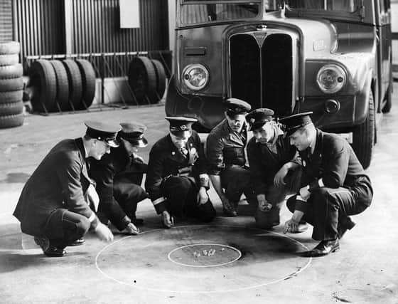 A group of Crawley busmen have a practice game of marbles in their bus garage in the 1930's. The team are out for revenge at the next world marbles championships, held, as it has been for the last 350 years, at Tinsley Green.