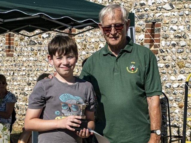 Toby Simmons receives the Children's Cup from Colin Crane at East Preston and Kingston Horticultural Society flower show