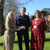 Frances Campion-Smith, Chief Executive at Holy Cross Hospital receives the cheque from run organiser Matt Dellar.