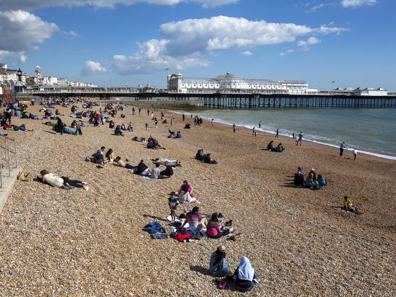 People enjoy the spring sunshine this Good Friday on Brighton beach in East Sussex.