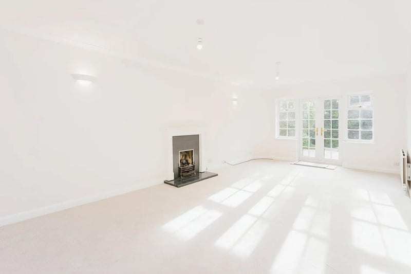The large dual-aspect sitting room has a fire, as well as French doors to the garden