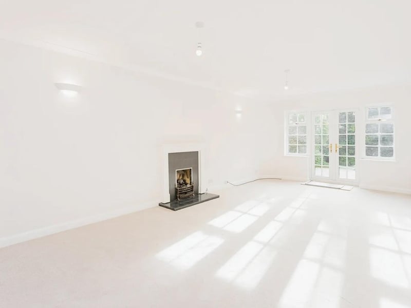 The large dual-aspect sitting room has a fire, as well as French doors to the garden