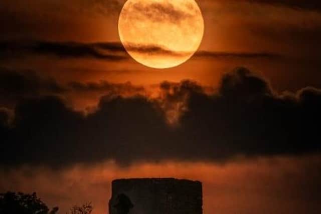 Taking the top spot in the “Magnificent Moon” category was an eerie image of a harvest moon rising over Racton Ruins, near Chichester, West Sussex.