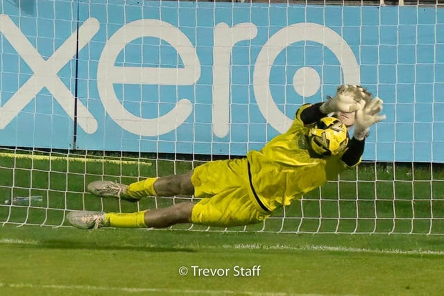 Bognor's goalkeeper Toby Stewart saves a Lewes Town FC penalty as fans look on in anticipation.:Action from Bognor Regis Town's win at Lewes FC in the FA Trophy