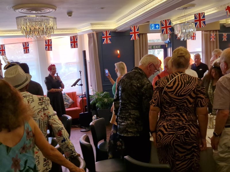 Vocalist Jenna Hall leads a rousing rendition of the National Anthem
