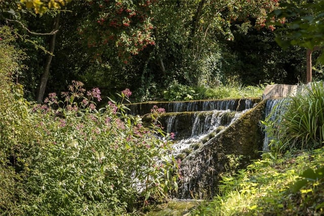 A picturesque waterfall is also in the property's ground grounds