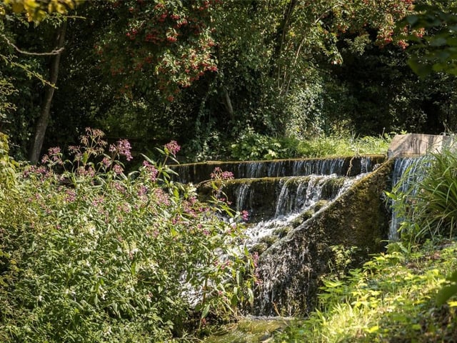 A picturesque waterfall is also in the property's ground grounds