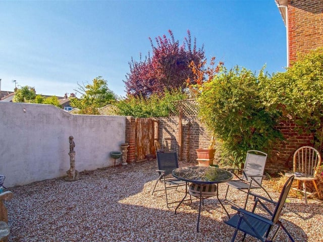 Outside, an attractive garden and off-street parking add further appeal