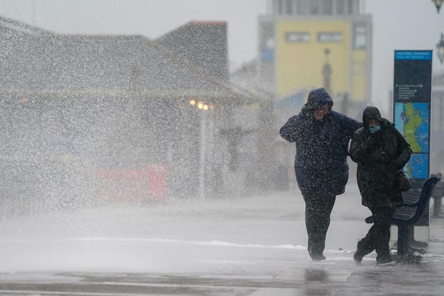 People brave the weather as they make their way along the seafront in Southsea as Storm Barra hit. Picture: Andrew Matthews/PA Wire