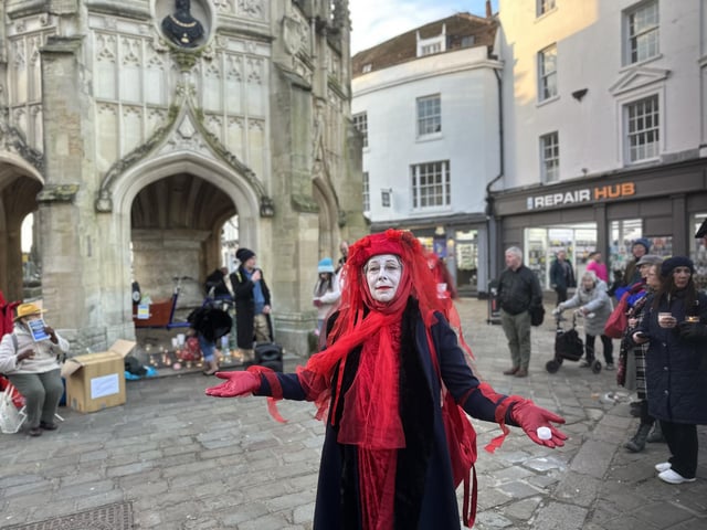 Participants gathered around the market cross.