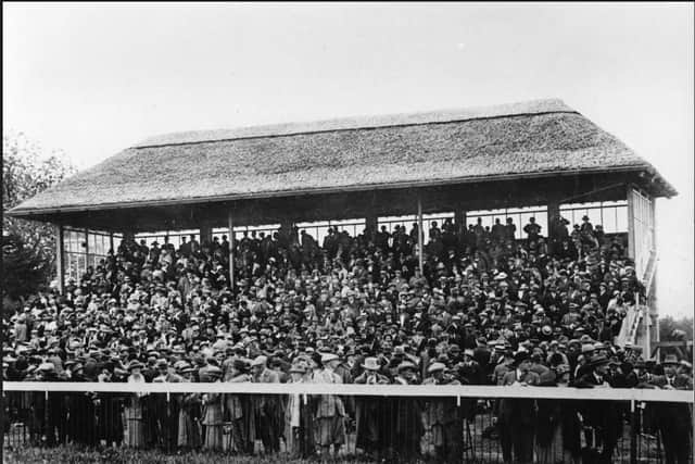 The original main stand with its thatched roof | Archive picture