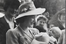 The Queen, then Princess Elizabeth, cradles Maurice Occleshaw in 1945, during a visit to Chailey Heritage