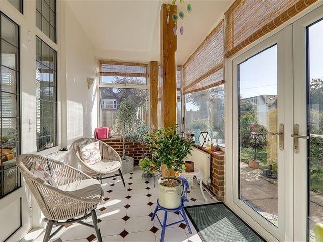 The double-aspect sun room has double-glazed French doors to the garden