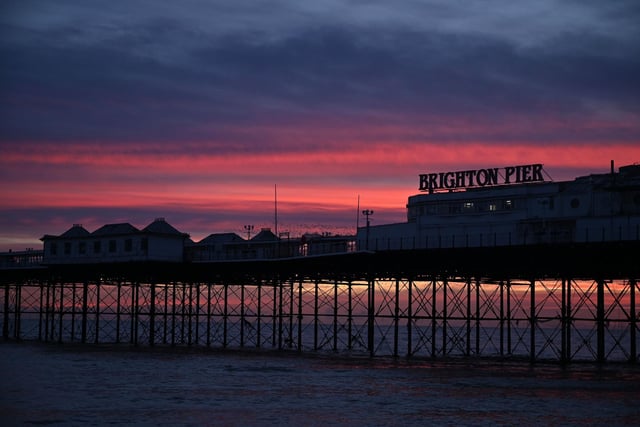 No visit to Sussex is complete without a trip to the iconic Brighton Pier. This Victorian pier offers fun attractions, such as amusement arcades, restaurants, and bars. (Photo by Glyn KIRK / AFP)