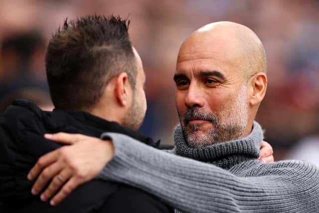 Roberto De Zerbi, manager of Brighton and Hove Albion, was greeted by Manchester City boss Pep Guardiola, prior to the Premier League match at the Etihad Stadium. (Photo by Naomi Baker/Getty Images)